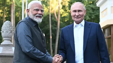 AFP via Getty Images Russia's President Vladimir Putin (right) welcomes Indian Prime Minister Narendra Modi (left), shaking hands, for an informal meeting at the Novo-Ogaryovo state residence, outside Moscow, 8 July 2024