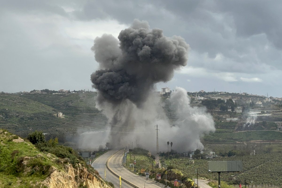 Smoke rises after an Israeli airstrike targets the Qasmiya Bridge, one of the key transit points connecting the southern and northern parts of the country, linking the city of Tyre in southern Lebanon to Sidon, on march 22, 2026. [Ahmad Kaddoura - Anadolu Agency]